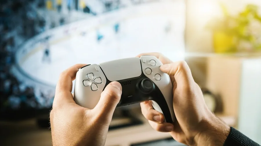 Person's hands holding gaming controller while playing video game with intense focus and concentration