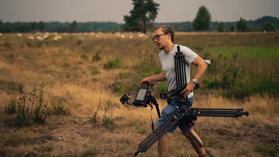 The %product_count% Best Tripods 2 Photographer carefully positioning heavy camera gear on tripod in outdoor setting