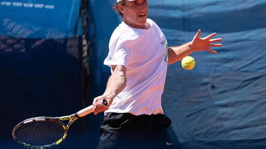 Pickleball player in action hitting ball on outdoor court during daytime play