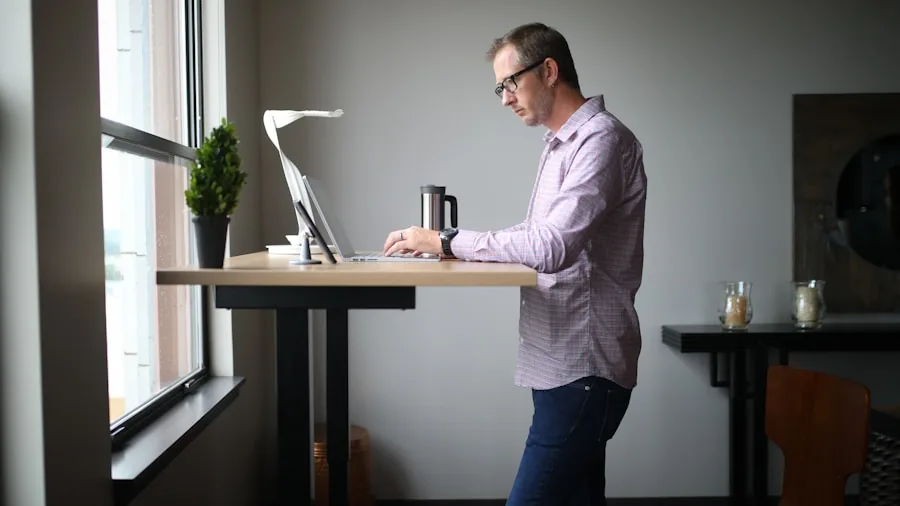 The %product_count% Best Computer Desks 3 Professional adjusting electric standing desk height while working in modern home office setup