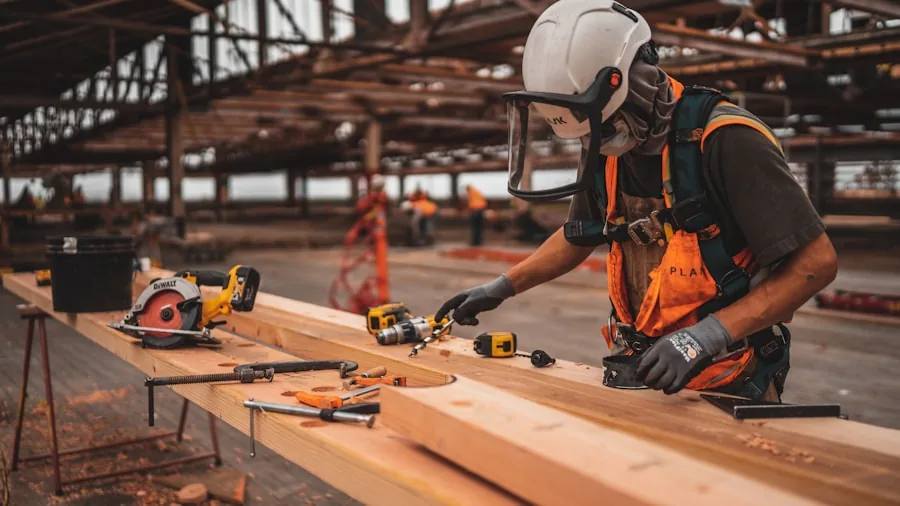 The 12 Best Nail Guns 5 Professional contractor using cordless nail gun on wooden construction project in workshop