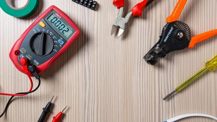 The %product_count% Best Reciprocating Saws 6 Professional electrician using compact tools while working in a confined space behind wall fixtures