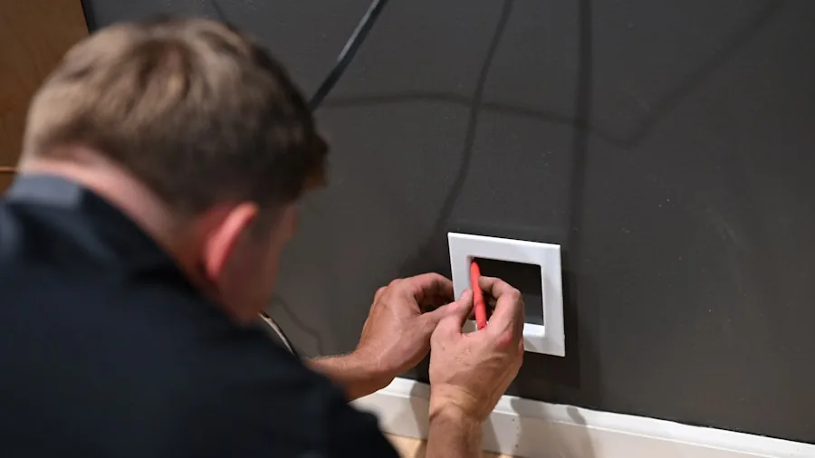 Professional electrician working on kitchen electrical installation and wiring setup