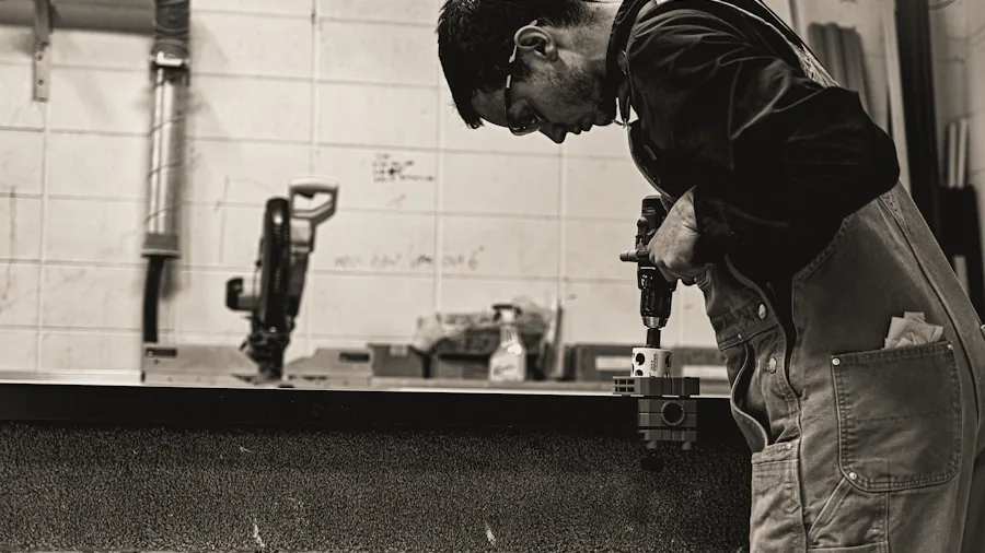 The %product_count% Best Ranges 6 Professional kitchen installer working on range installation with tools and safety equipment