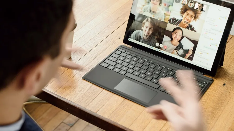 Professional taking a video call at desk with focused expression during work meeting