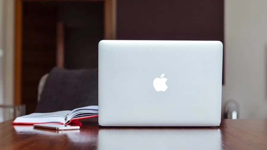 The %product_count% Best Laptops for Video Editing 6 Professional video editor connecting external hard drives and monitors to laptop at creative workspace