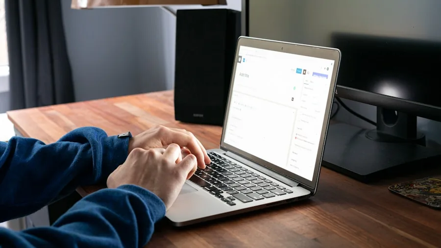 Professional working at desk with laptop, focused on keyboard typing and work