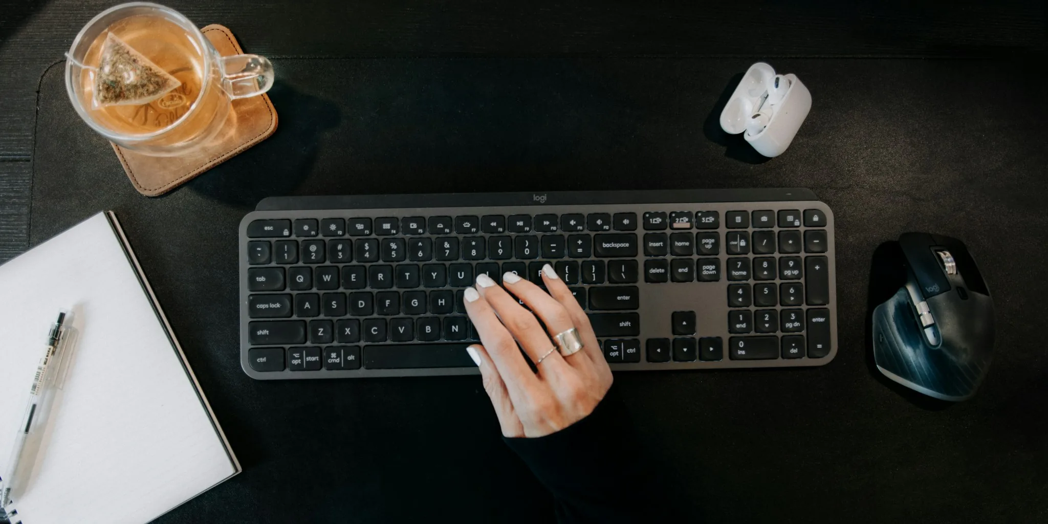 Professional working at desk with wireless keyboard in modern home office setup