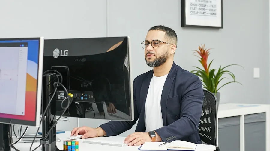 Professional working at desktop computer workstation in home office environment