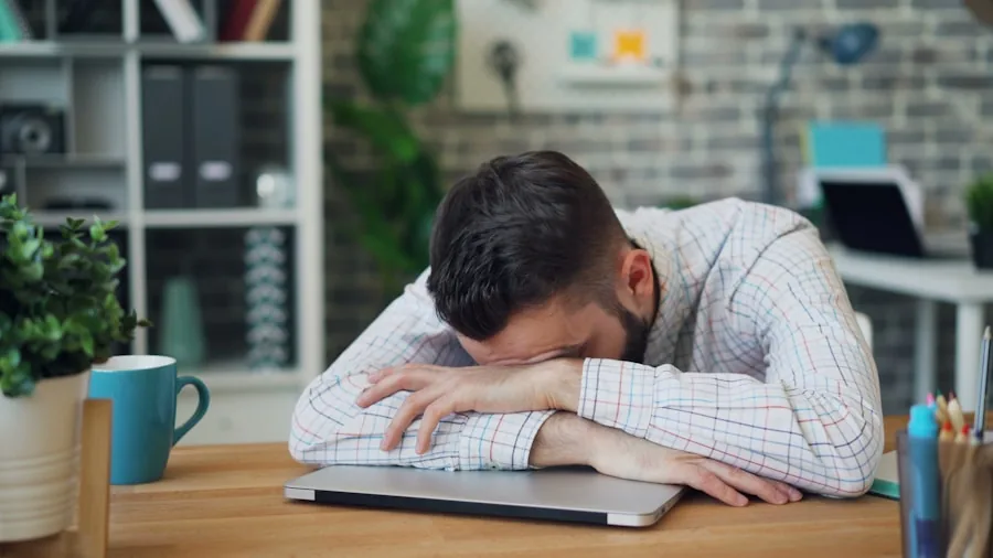 Professional working at laptop desk during long workday focusing on screen
