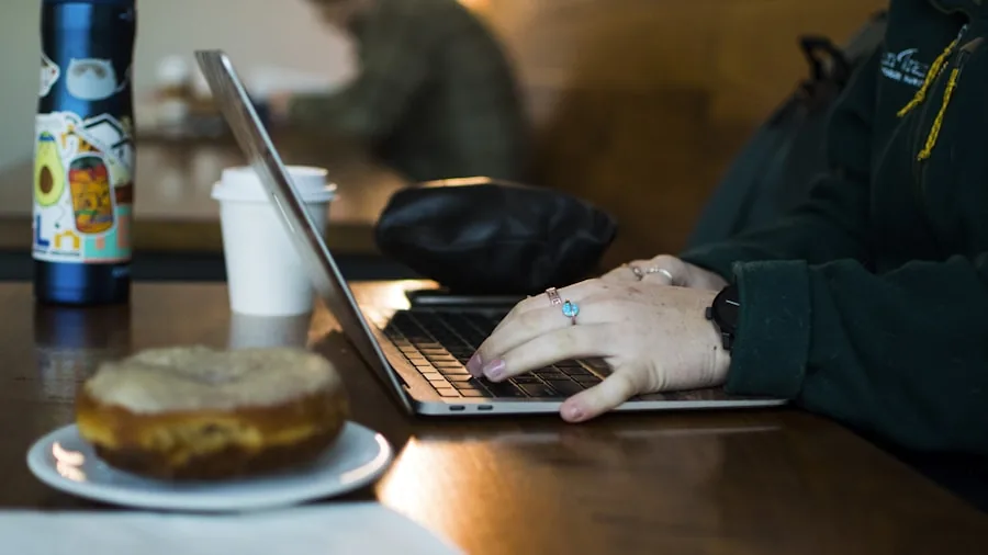 Premium Laptop With OLED Screen Drops Over $400 at Best Buy: What Shoppers Need to Know 2 professional working from cafe laptop