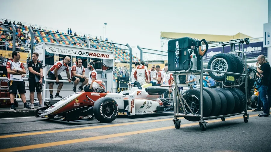 Porsche Releases New 911 Challenge Race Car in 2027: What Buyers Should Know 2 race car pit crew changing tires