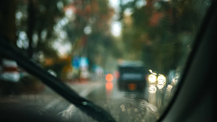 Rain droplets on car windshield during storm showing water damage risks