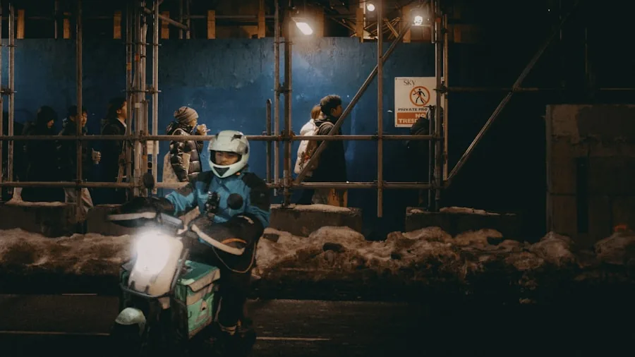 Rider on scooter during winter conditions, demonstrating real-world battery performance in cold temperatures.