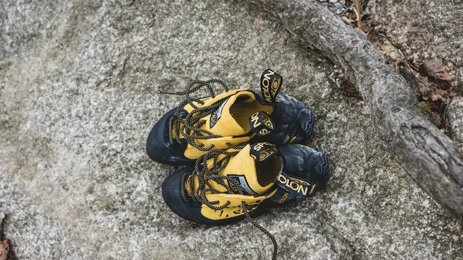 The %product_count% Best Climbing Shoes 3 Rock climber examining and testing climbing shoe fit while preparing for outdoor climbing adventure