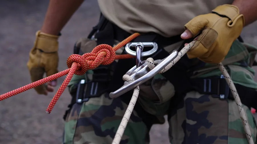 The %product_count% Best Climbing Harnesses 3 Rock climber inspecting harness and equipment before climbing on natural cliff face