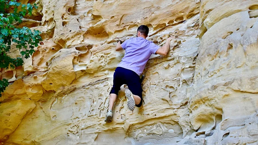 The %product_count% Best Climbing Shoes 6 Rock climber scaling natural stone wall in outdoor climbing environment