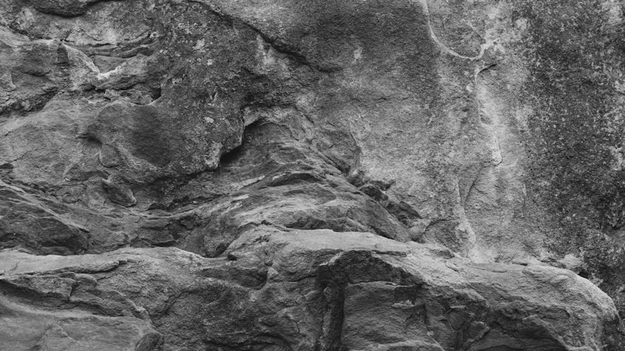 The %product_count% Best Climbing Harnesses 2 Rock climber's hand touching rough rock surface during outdoor climbing