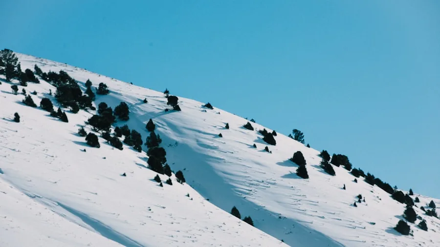Skier enjoying bright sunny conditions on a high altitude snowy mountain slope with clear visibility