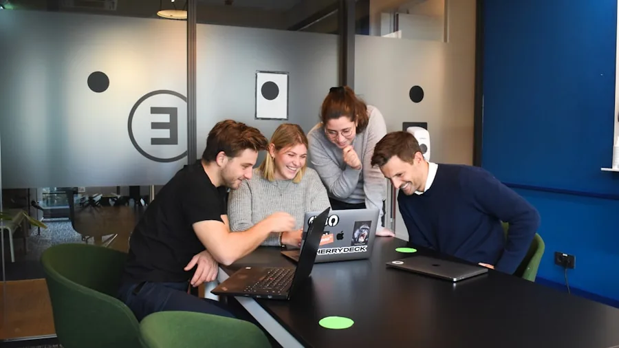 Small business team collaborating in modern office workspace with multiple workstations