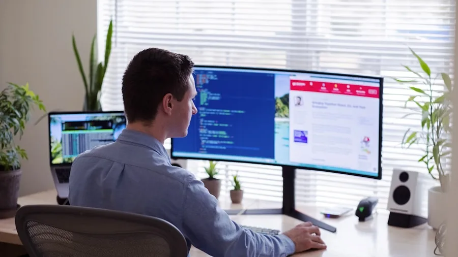 Software developer focused on laptop screen while coding at workspace