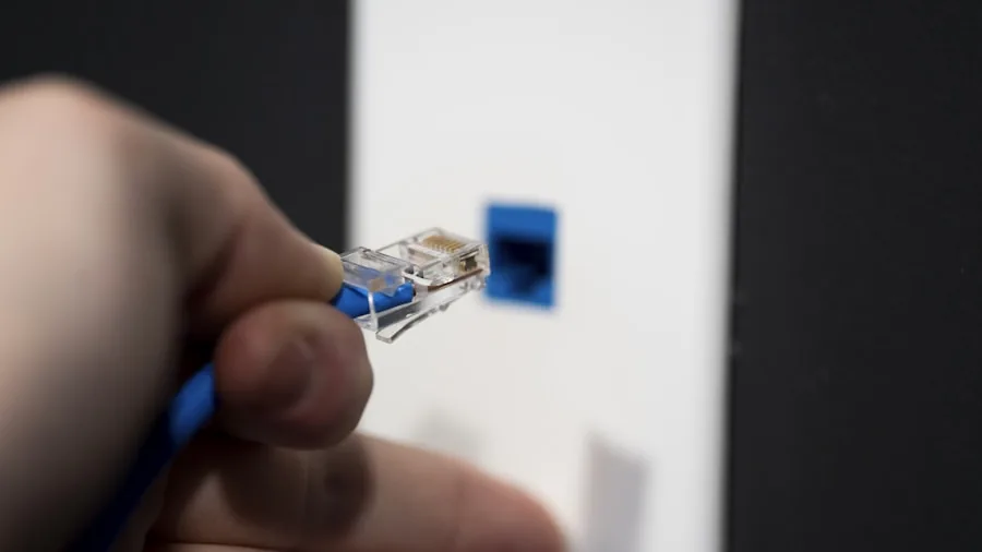 The %product_count% Best Mesh Routers 4 Someone connecting ethernet cables to router equipment in a home office setup for network installation