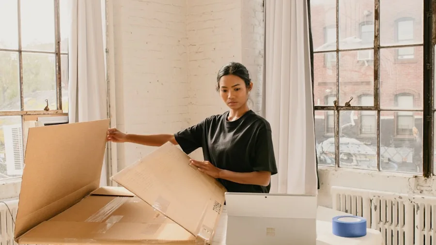 student unpacking new laptop desk
