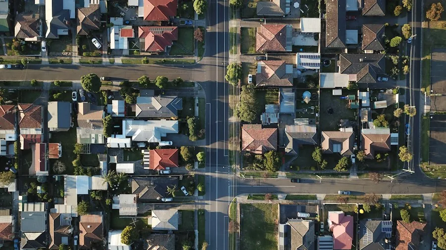 Mowing Your Neighbor's Lawn Without Permission: Legal Risks Every Homeowner Should Know 2 suburban homes close together property lines