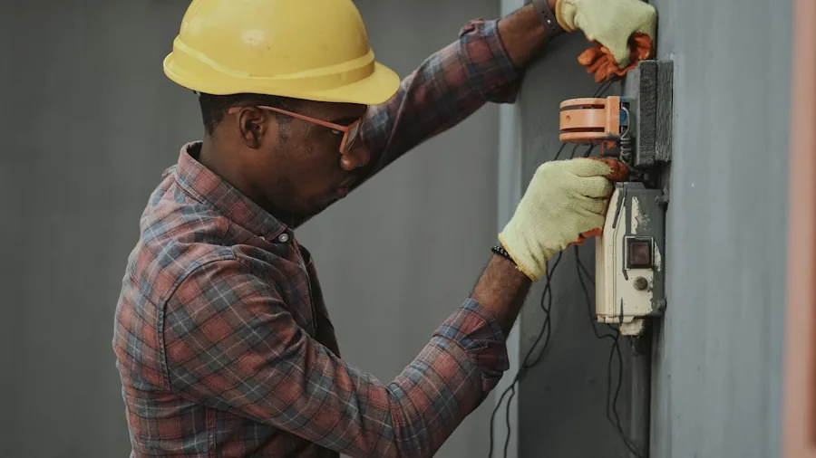 Technician inspecting electrical outlet and power connections in a workshop setting