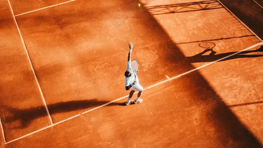 Tennis player mid-swing on outdoor court demonstrating proper racket technique and form