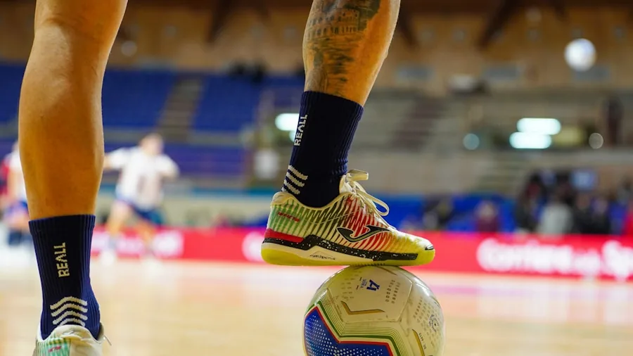 Volleyball player executing a pivot move on hardwood court during competitive match
