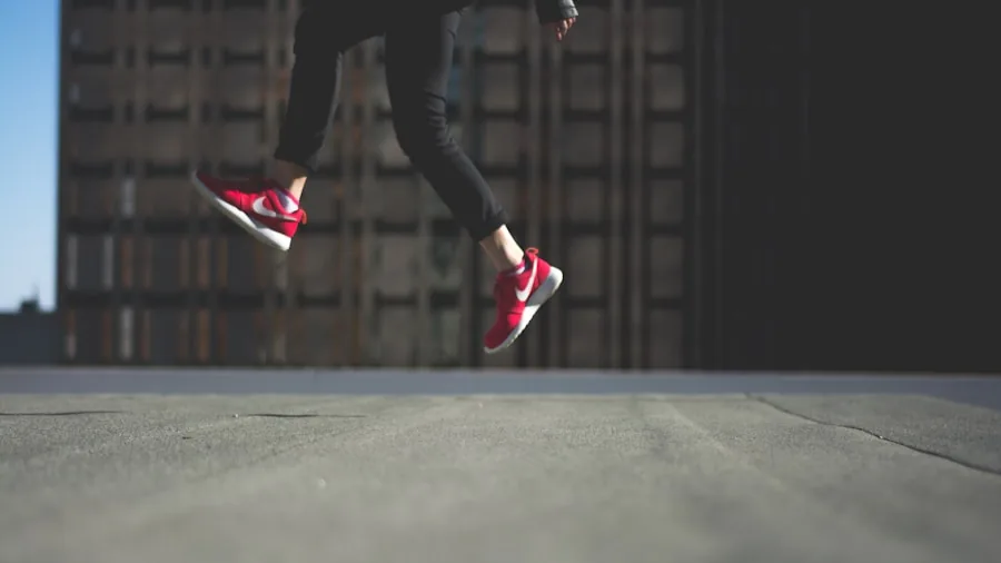 Volleyball player mid-air jump with dynamic landing motion on indoor court