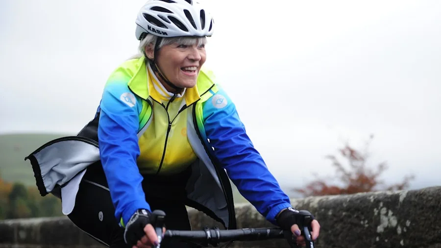Woman commuting by bicycle wearing a rain jacket on a wet urban street