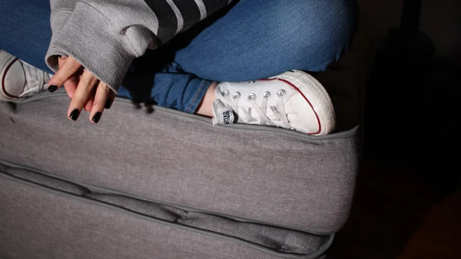 The 11 Best Sleeper Sofas 5 Woman effortlessly converting a sleeper sofa into a bed in a modern living room