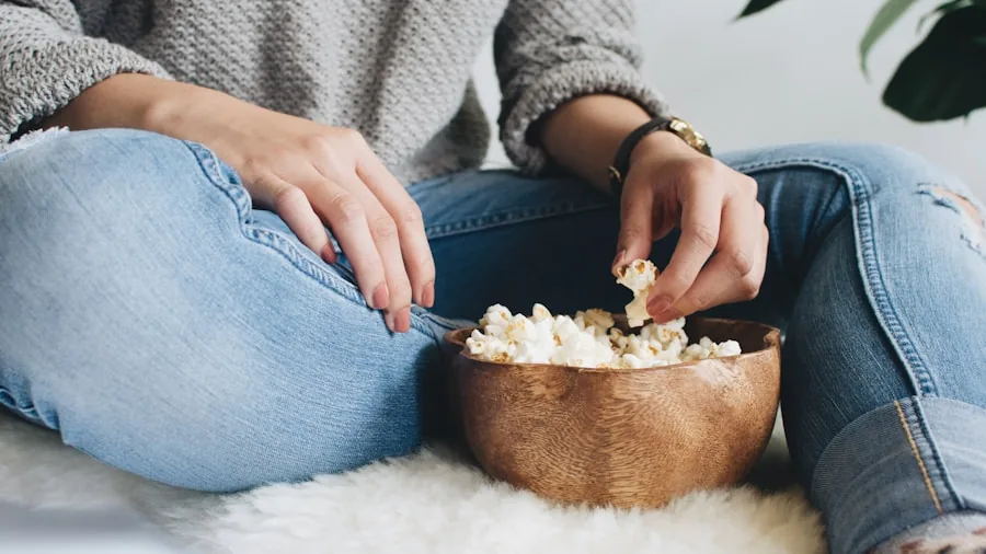 6 Tips for Choosing the Right TV for Streaming Live Sports 2 woman enjoying television with popcorn