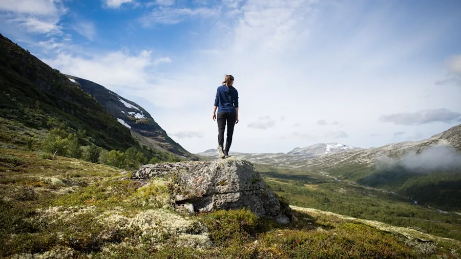 The %product_count% Best Hiking Pants for Women 6 Woman hiker adjusting layers on mountain trail during seasonal weather transition