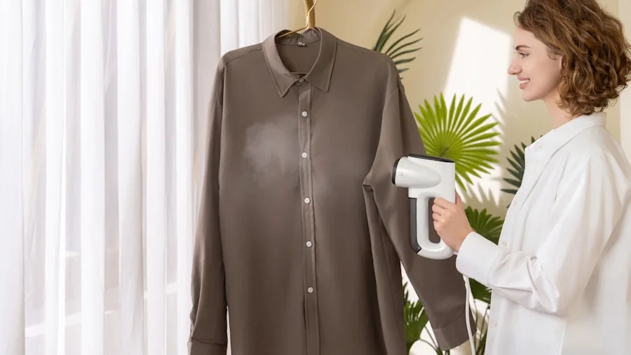 Woman in home holding clothing steamer while pressing garments, demonstrating ergonomic grip and comfort during use