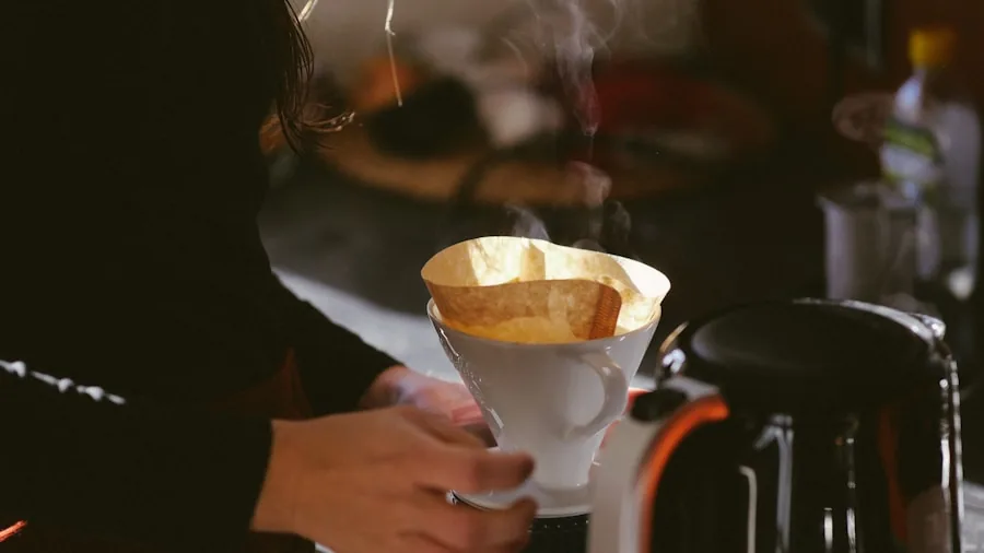 The %product_count% Best Single Serve Coffee Makers 5 Woman in kitchen watching coffee maker brew in morning light, focused on efficient appliance use