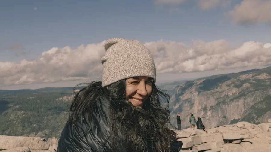 The %product_count% Best Ski Jackets for Women 3 Woman in winter gear hiking on snowy mountain slope, demonstrating warm layering for cold weather activities