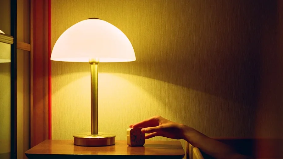 The 12 Best Table Lamps 2 Woman measuring lamp height on nightstand to ensure proper proportions for seated eye level