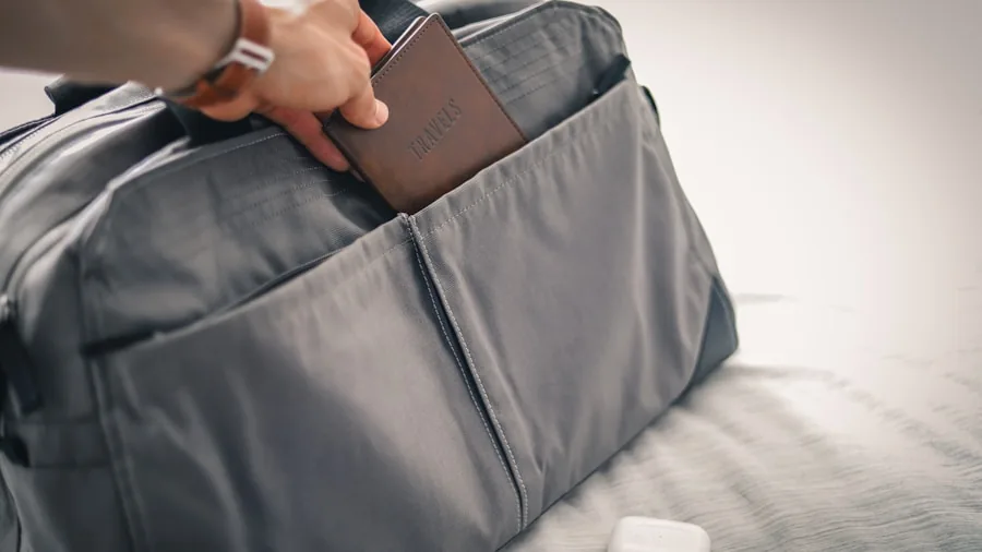 Woman organizing fitness gear in travel bag before gym commute