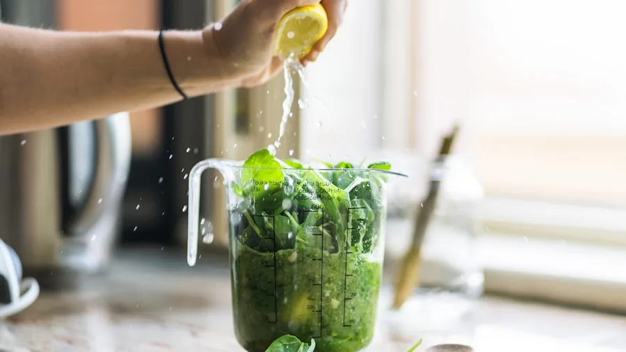 Woman using a powerful blender to mix frozen fruits and leafy greens for a healthy smoothie at home