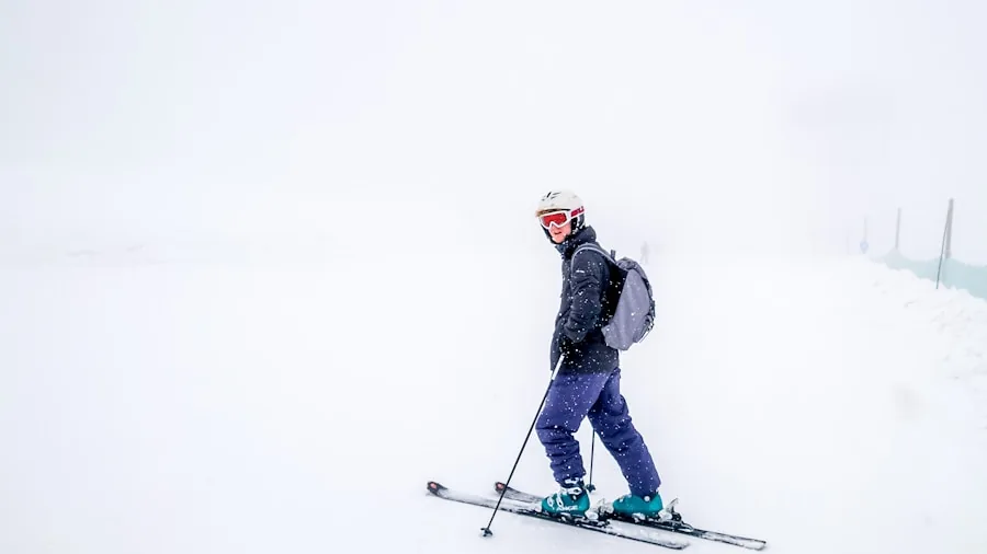 The %product_count% Best Ski Jackets for Women 5 Woman wearing ski helmet and jacket in snowy mountain weather conditions