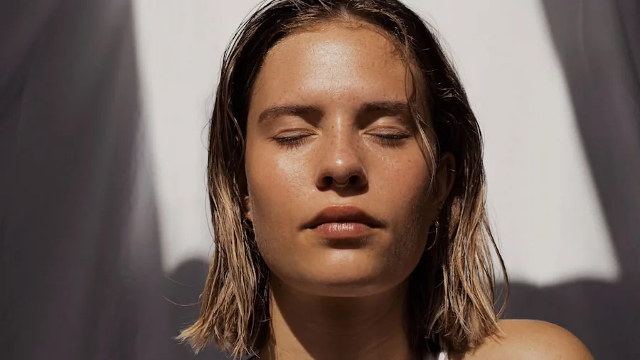 Woman with radiant, hydrated skin touching her face in natural morning light