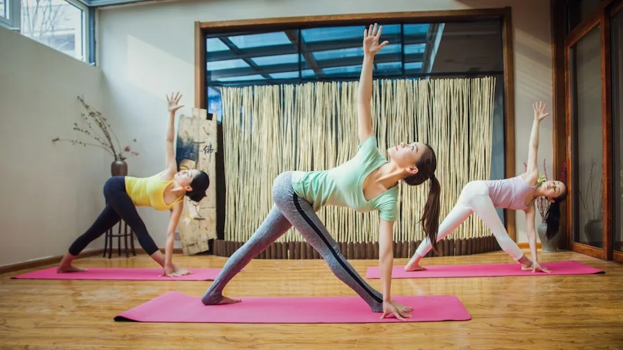Romantasy Fitness Workouts Are Surging Among Women: What Buyers Need to Know 2 women strength training sword yoga