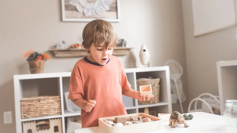 Young child displaying and playing with collectible toy figurines and miniature characters on a table