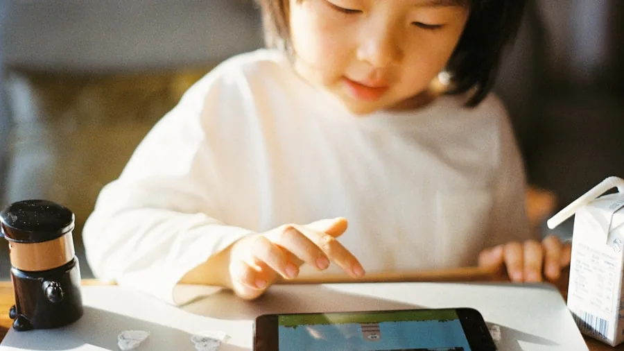 Young child exploring a mobile device with parent guidance, demonstrating age-appropriate technology use