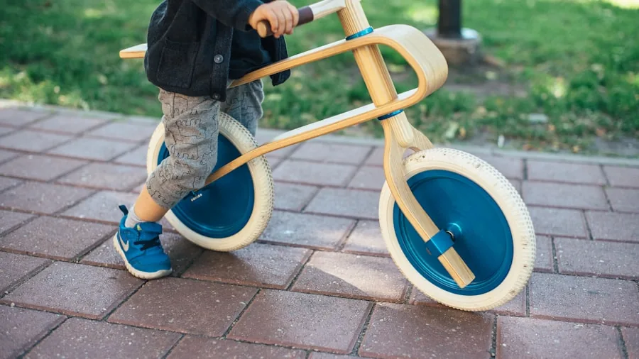The %product_count% Best Balance Bikes 3 Young child riding a balance bike on a paved path, learning to balance and push with feet.