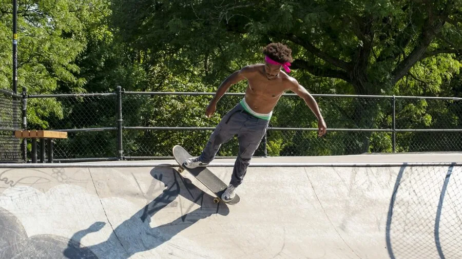 The %product_count% Best Skateboard Wheels 6 Young skateboarder executing a flip trick on urban street pavement