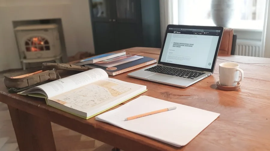 Young student studying at wooden desk with focused lighting in minimalist home office space